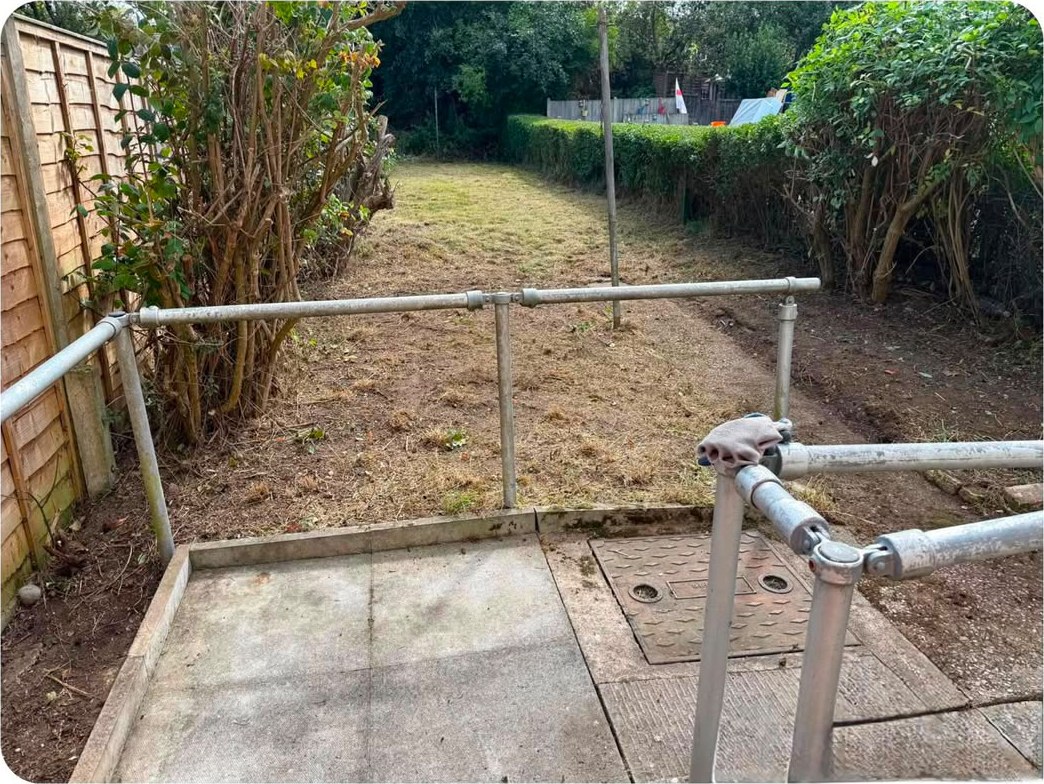 The same garden cut right back, showing open ground, a trimmed hedge and a clear path
